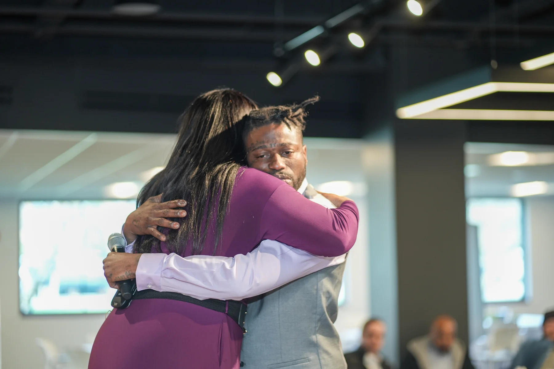 Host embracing a participant during the RAWNY conference