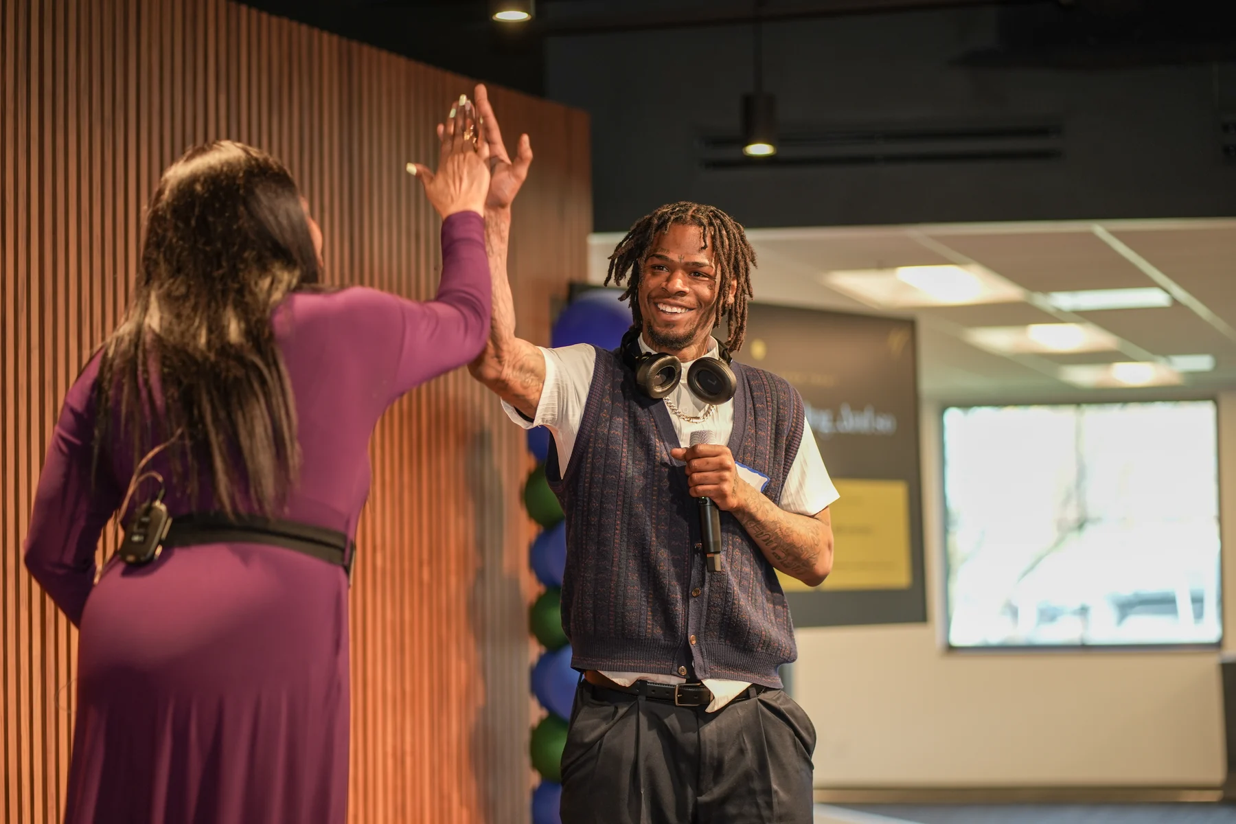 Speaker and host exchanging a high five during RAWNY Reentry Week