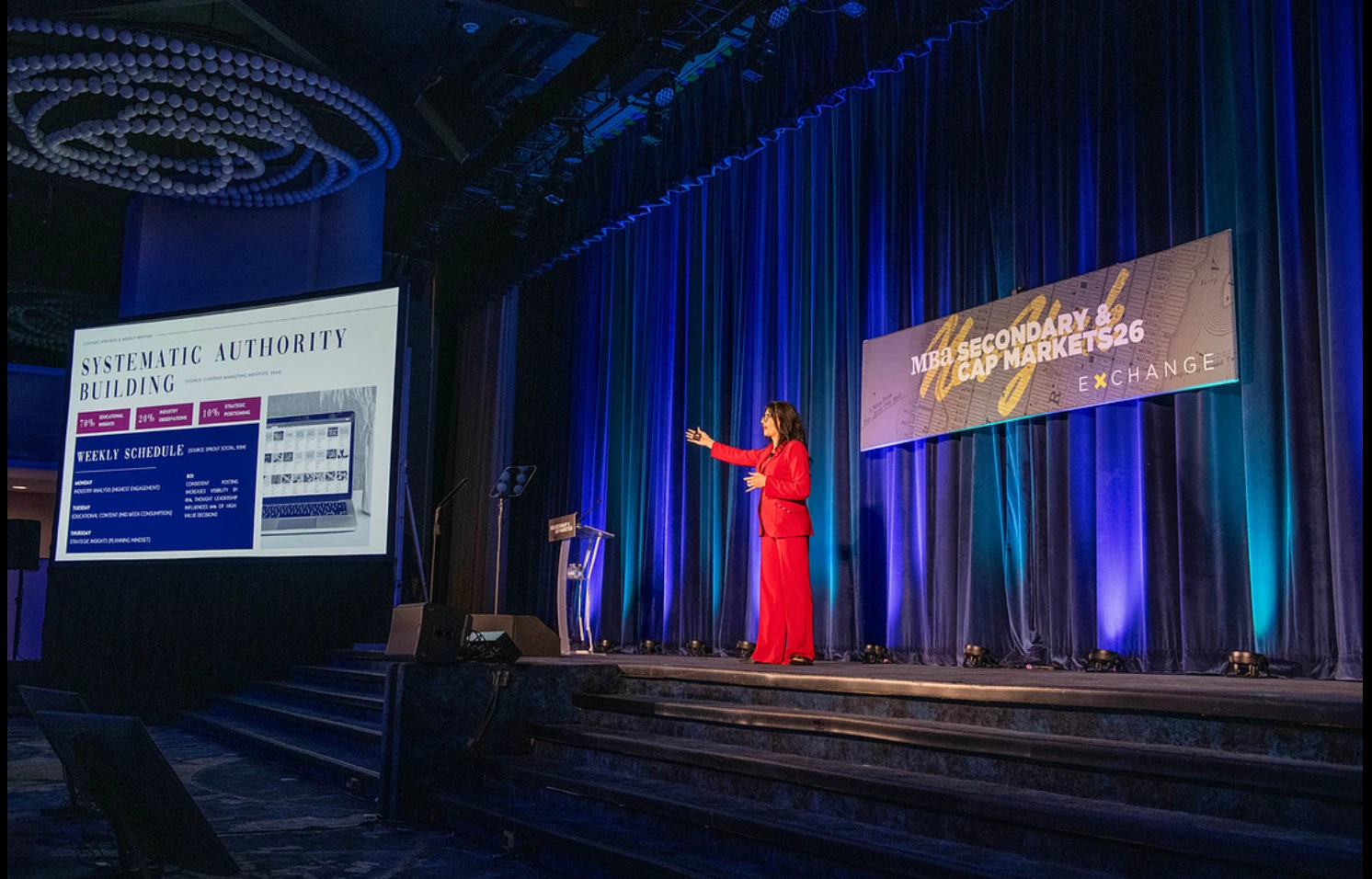 Stephanie Armstrong presenting on stage at the MBA Secondary and Capital Markets conference
